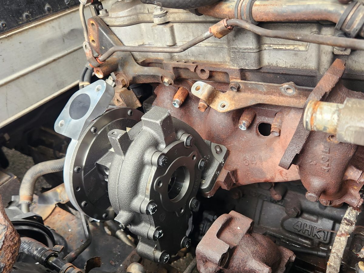 New turbocharger installed on a rusted 2014 Isuzu NPR diesel engine